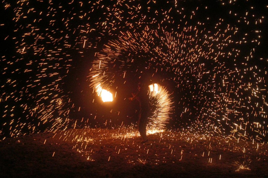 A mesmerizing fire dancer creates dazzling light patterns in Agafay Desert, Morocco.