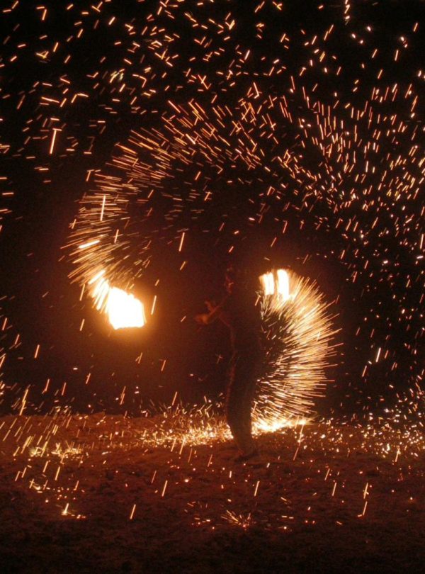 A mesmerizing fire dancer creates dazzling light patterns in Agafay Desert, Morocco.