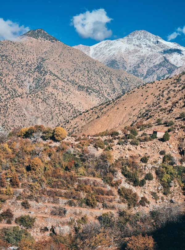 a view of a mountain range with a house in the foreground