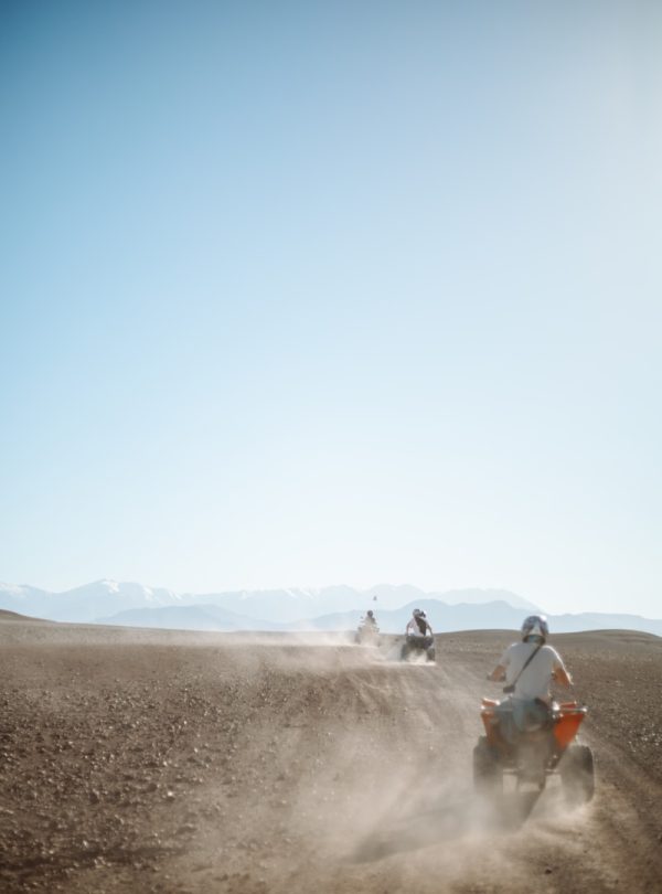 people riding camel on desert during daytime