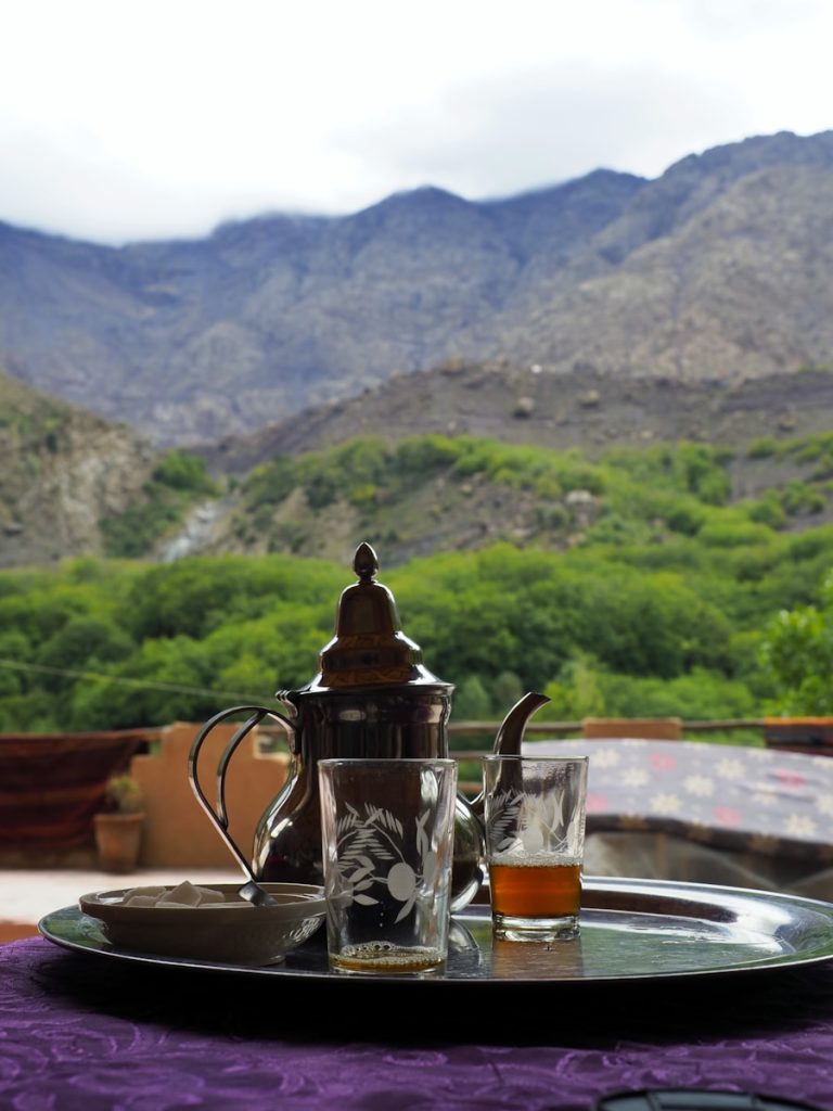 A tray with a tea pot and two glasses on it
