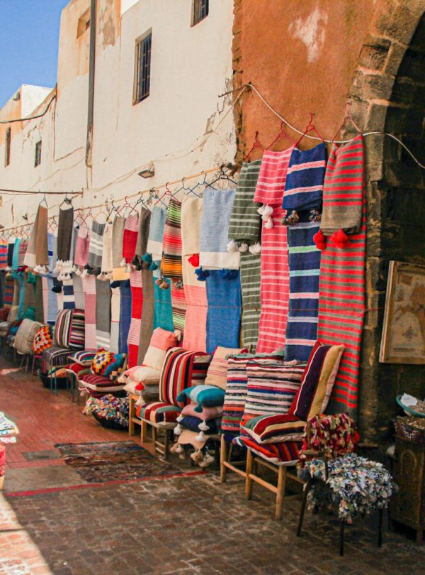 a street with a bunch of chairs and rugs