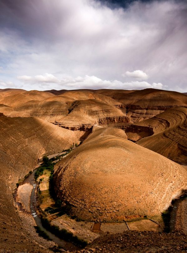 brown mountain under white clouds during daytime