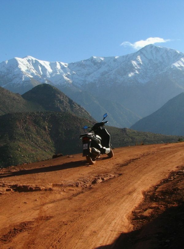 black motor scooter parked on road during daytime