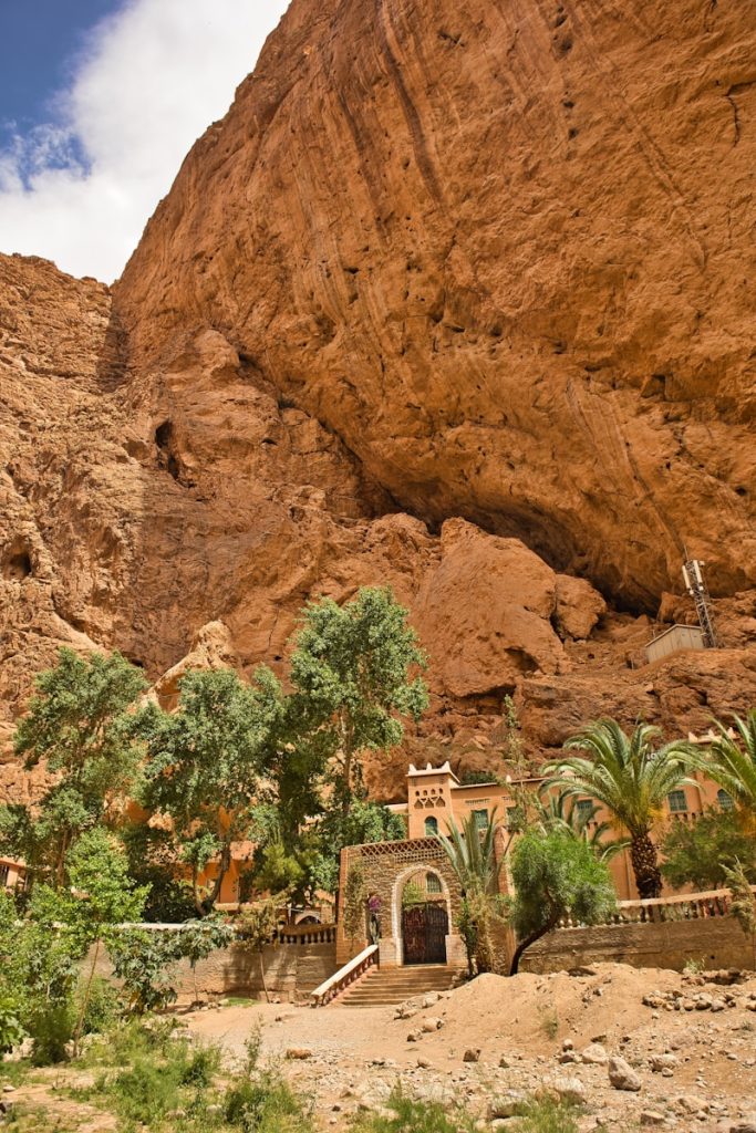 A large rock formation with a building in the middle of it