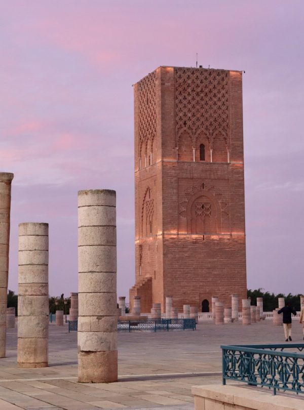 A group of pillars sitting next to a tall building