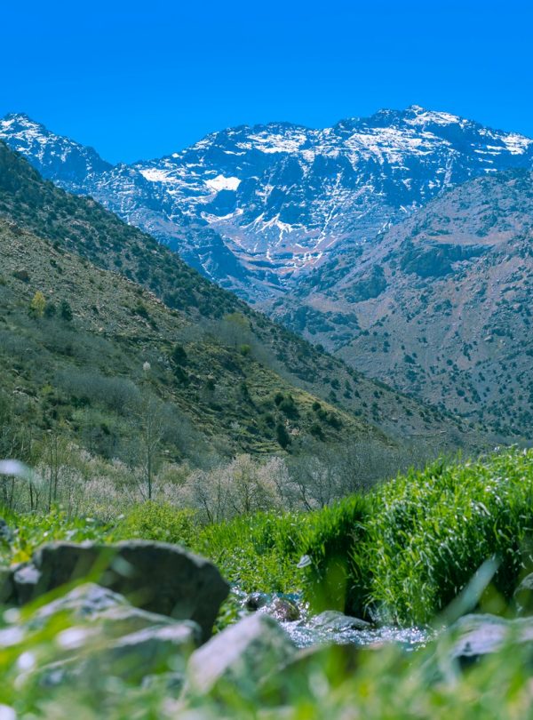 a view of a mountain range with a stream running through it